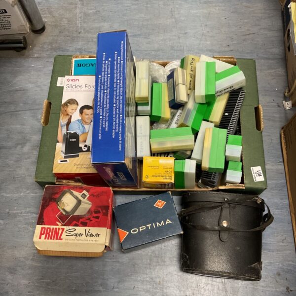 Vintage 35mm slide collection with viewer and binoculars.