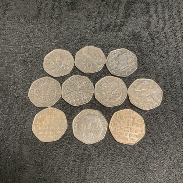 Collection of ten commemorative 50p coins, including Beatrix Potter designs.