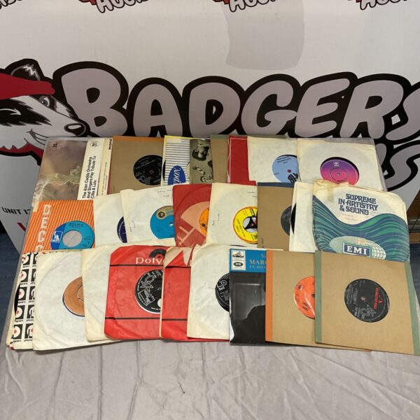 Selection of vintage 7 inch single vinyl records in varied sleeves, including Barry White
