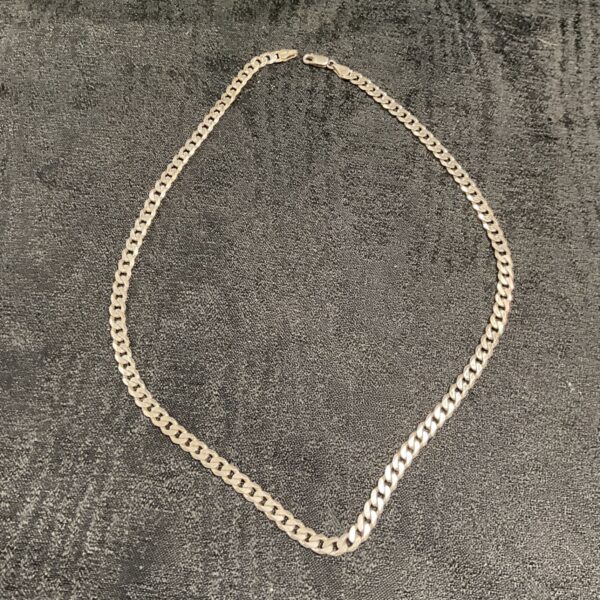 925 silver curb chain necklace laid out flat on a dark surface
