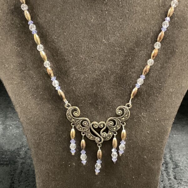 Silver marcasite and crystal necklace with scrolling openwork pendant and lilac drops