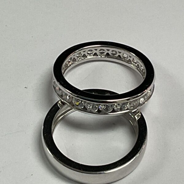 Two 925 silver rings, one with a row of white stones around the band.