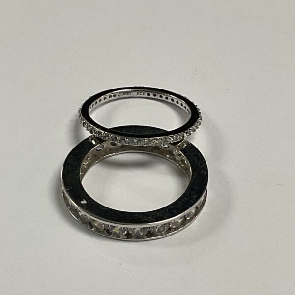 Two 925 silver rings set with white stones, one narrow and one wide band