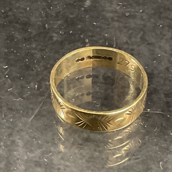 Close-up of a 9ct gold band ring, size O.