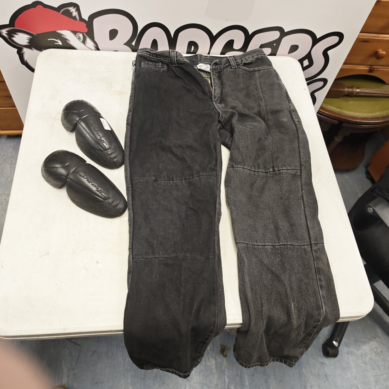 Pair of dark Acesport protective jeans with two black RST knee pads