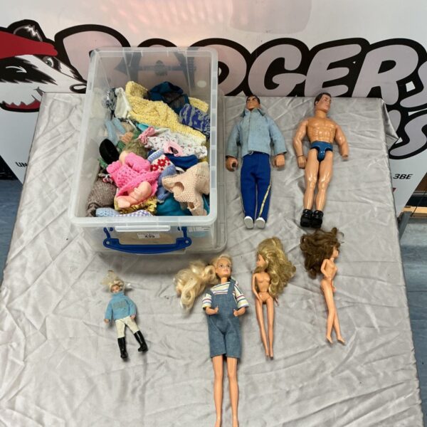 Action Man and Barbie dolls with box of doll clothing and accessories