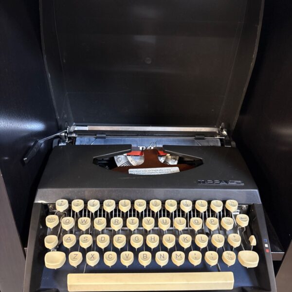 Vintage Adler Tippa S portable manual typewriter with black casing and cream keys