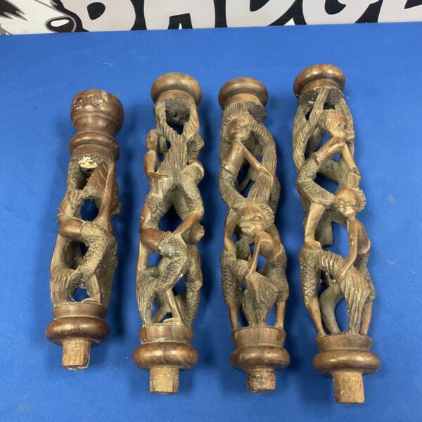 Antique African carved lamp pole with detailed human figure carvings.