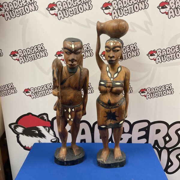 Pair of large hand-carved African tribal figurines with bone inlay.