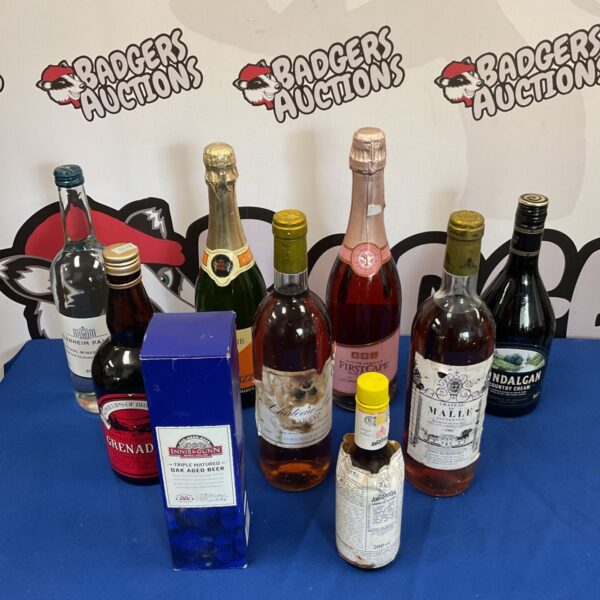 Vintage alcohol lot featuring Château de Malle wine and Philips grenadine bottles.