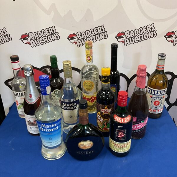 Assorted vintage alcohol bottles including Marie Brizard liqueur.