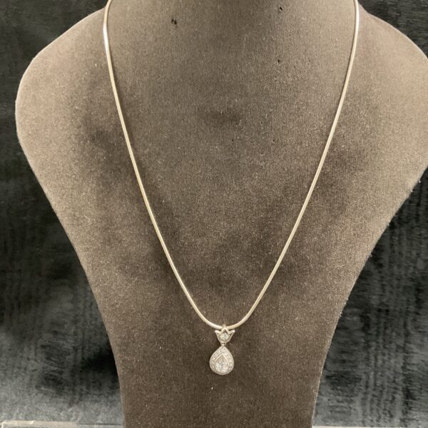 Silver teardrop pendant necklace by Althorp, displayed on a mannequin.