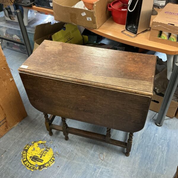 Antique barley twist gate leg table with a circular top.