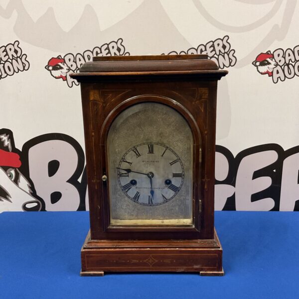 Antique H A C Bravingtons bracket clock with wooden case and Roman numeral dial.