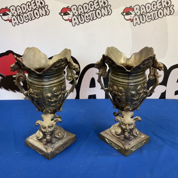Antique brass putti garniture pair with detailed figural masks.