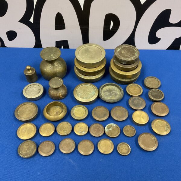 Antique brass weights in a collection, vintage scale weights.
