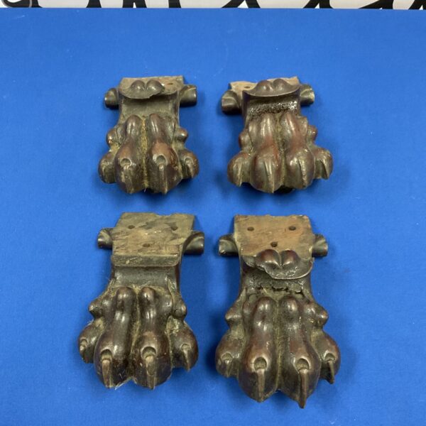 Set of four antique carved wooden claw feet with dark patina