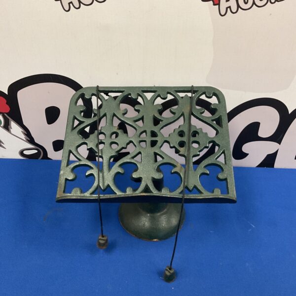 Antique cast iron pedestal book stand with intricate Victorian detailing.