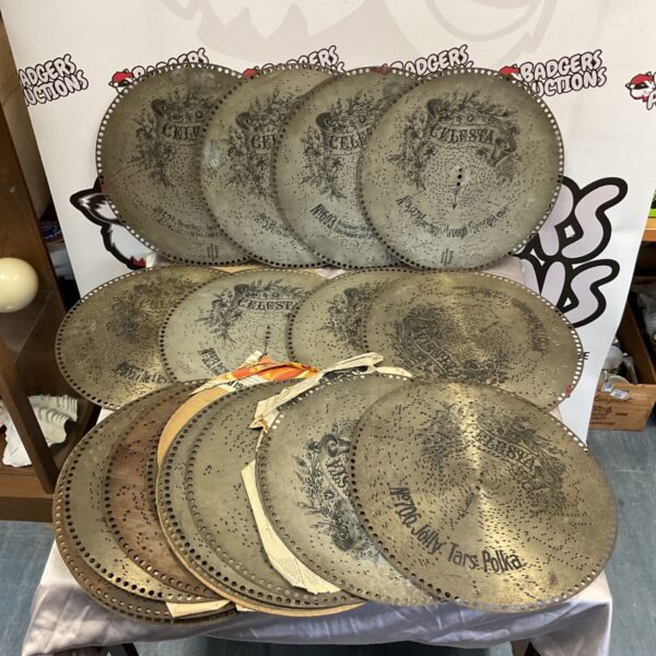 Stack of antique perforated metal Celesta music box discs with floral decoration