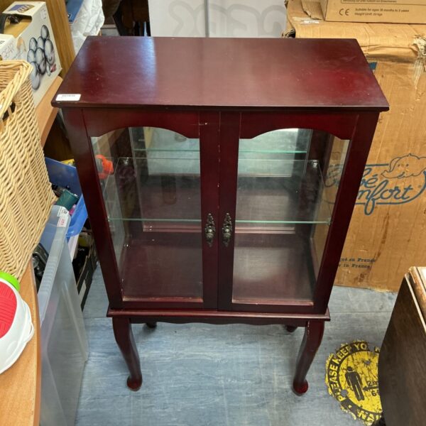 Antique china display cabinet with glazed door and dark wood finish.