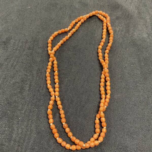 Antique handknotted coral bead necklace, 45 inches long.