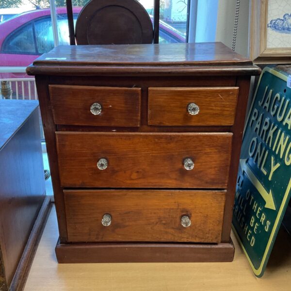 Antique 2 over 2 desktop drawers with translucent knobs for storage.