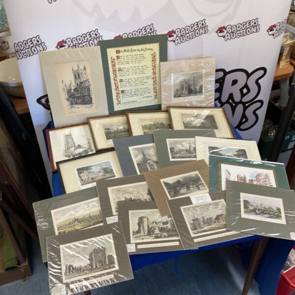 Collection of antique engravings and etchings on display.