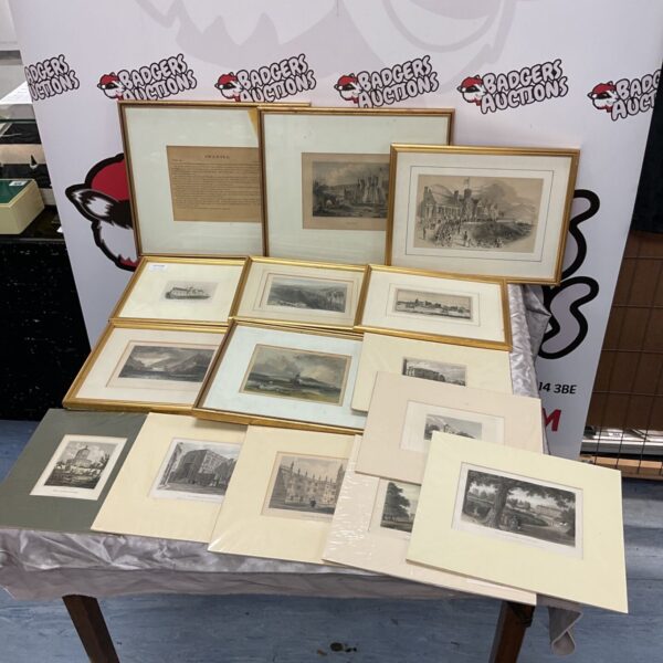 Collection of framed and mounted antique engravings and etchings on a table