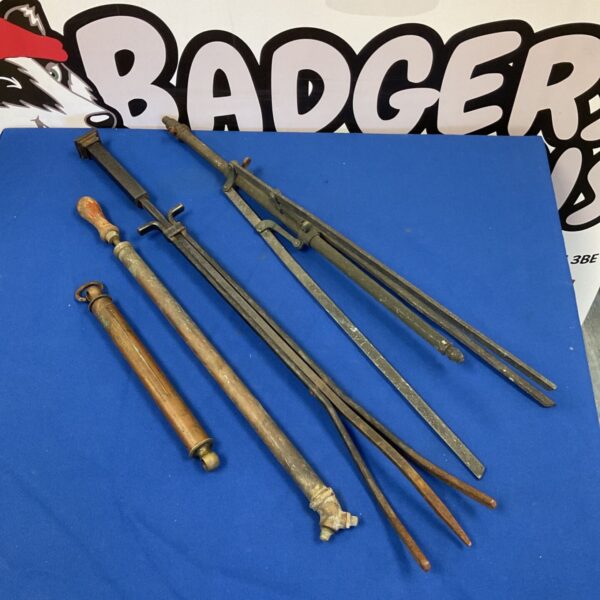Antique fireplace tools and a vintage copper plant sprayer on display.