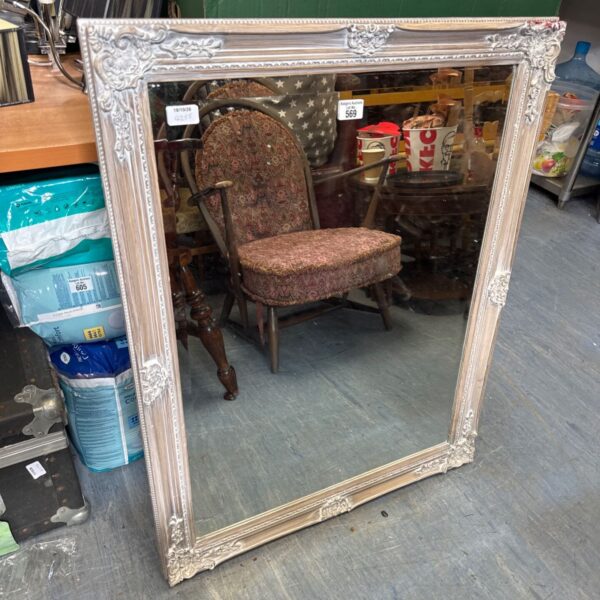 Large antique framed mirror with ornate detailing and bevelled glass.