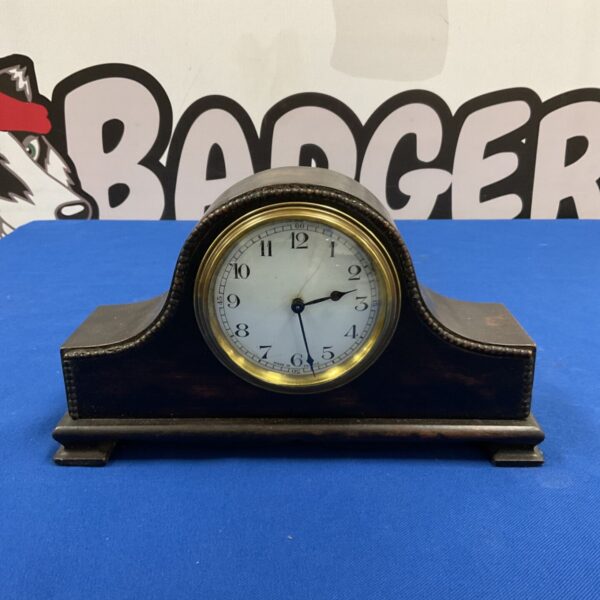 Antique French Napoleon hat mantel clock with dark wooden case and white dial