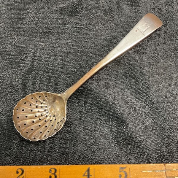 Antique Irish silver shell sifter spoon with pierced bowl and engraved terminal