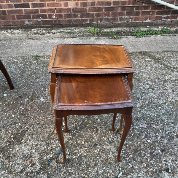 Antique mahogany nest of side tables with curved legs.