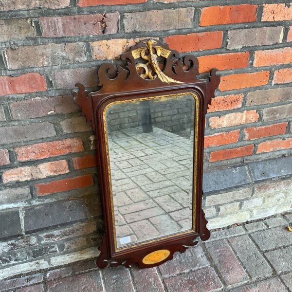 Antique mahogany wall mirror with gilt bird crest and inlaid oval base