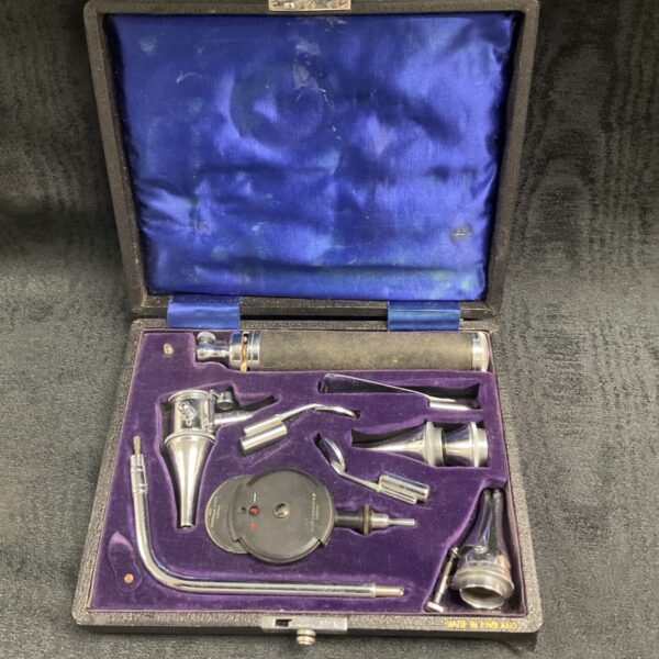 Antique ophthalmoscope set in open velvet-lined case.