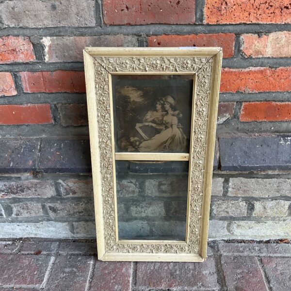 Antique picture frame with romantic pastoral print for vintage decor.