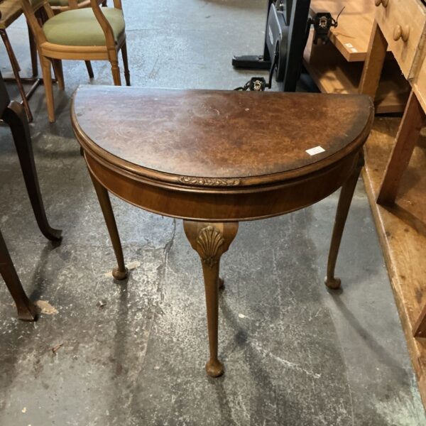 Antique Queen Anne style demilune table with cabriole legs and carved shell motif