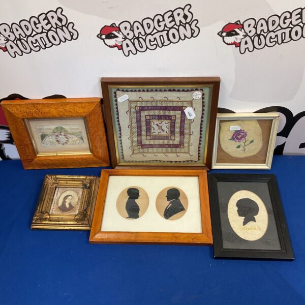 Antique collection of framed silhouettes and embroidered panels.