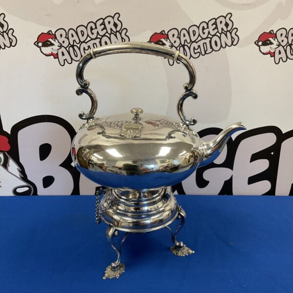 Antique silver plate tilting kettle with spirit burner on stand.