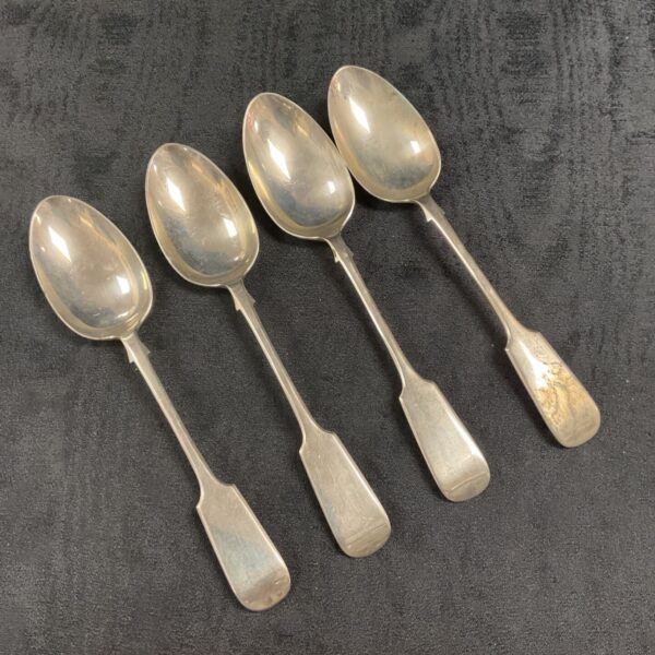 Antique silver serving spoons, a set of four vintage Georgian style utensils.