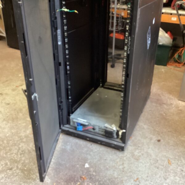 Black APC server cabinet with open mesh door showing internal mounting rails
