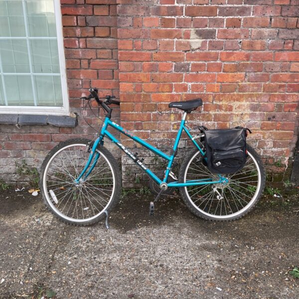 Turquoise Apollo Fever women's mountain bike with pannier rack.