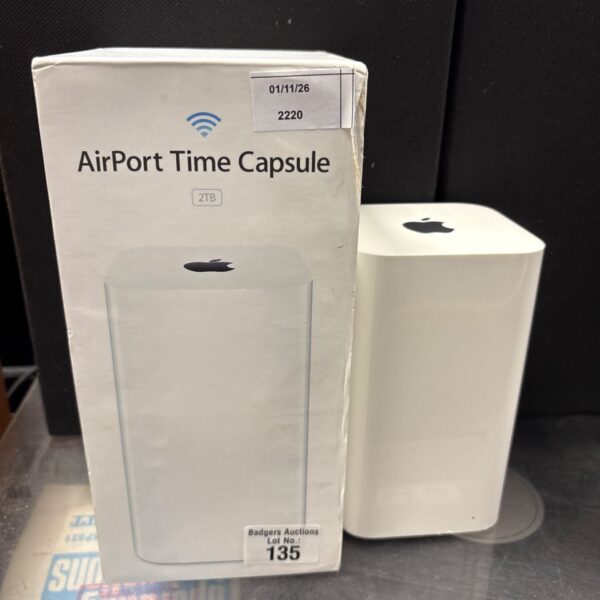 Apple AirPort Time Capsule 2TB tower box beside white unit