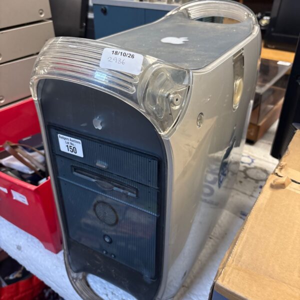 Vintage Apple Power Mac G4 computer in a cluttered environment.