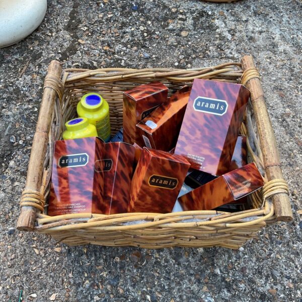 Vintage Aramis toiletries lot in a woven basket.