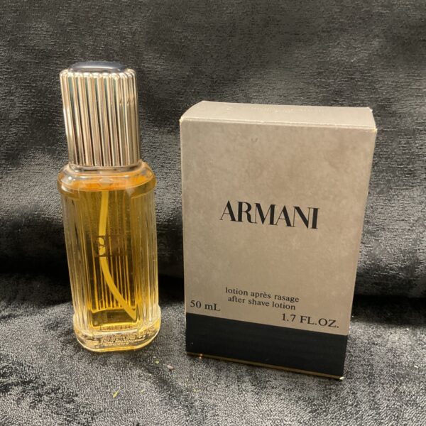 Vintage Armani aftershave lotion in a clear ribbed glass bottle.