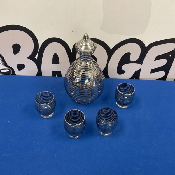 Vintage Art Deco glass decanter set with glasses on display.