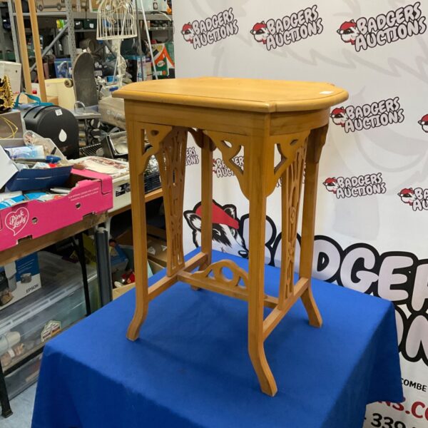 Elegant Art Nouveau table with carved details, side view.