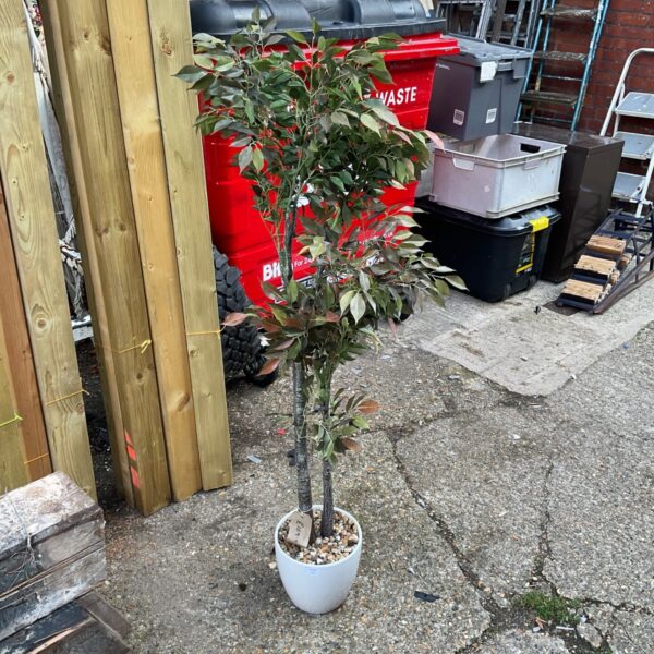 Artificial tree in white pot, a decorative faux plant for home.
