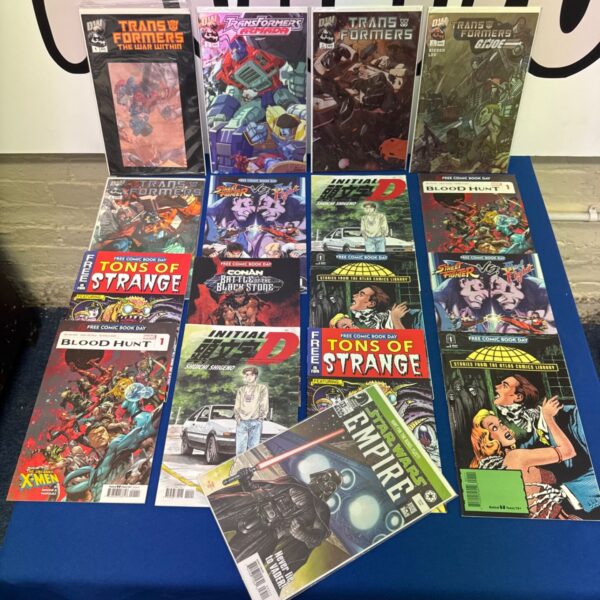 Assorted collectors comics lot with Transformers, Star Wars and Street Fighter titles laid out